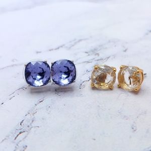 2 pairs of 3/8 inch earrings in silvertone and goldtone Violet and clear stones